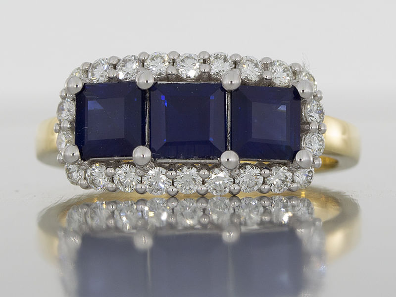 durham rose mixed metal sapphire trilogy ring with a cluster of diamonds front